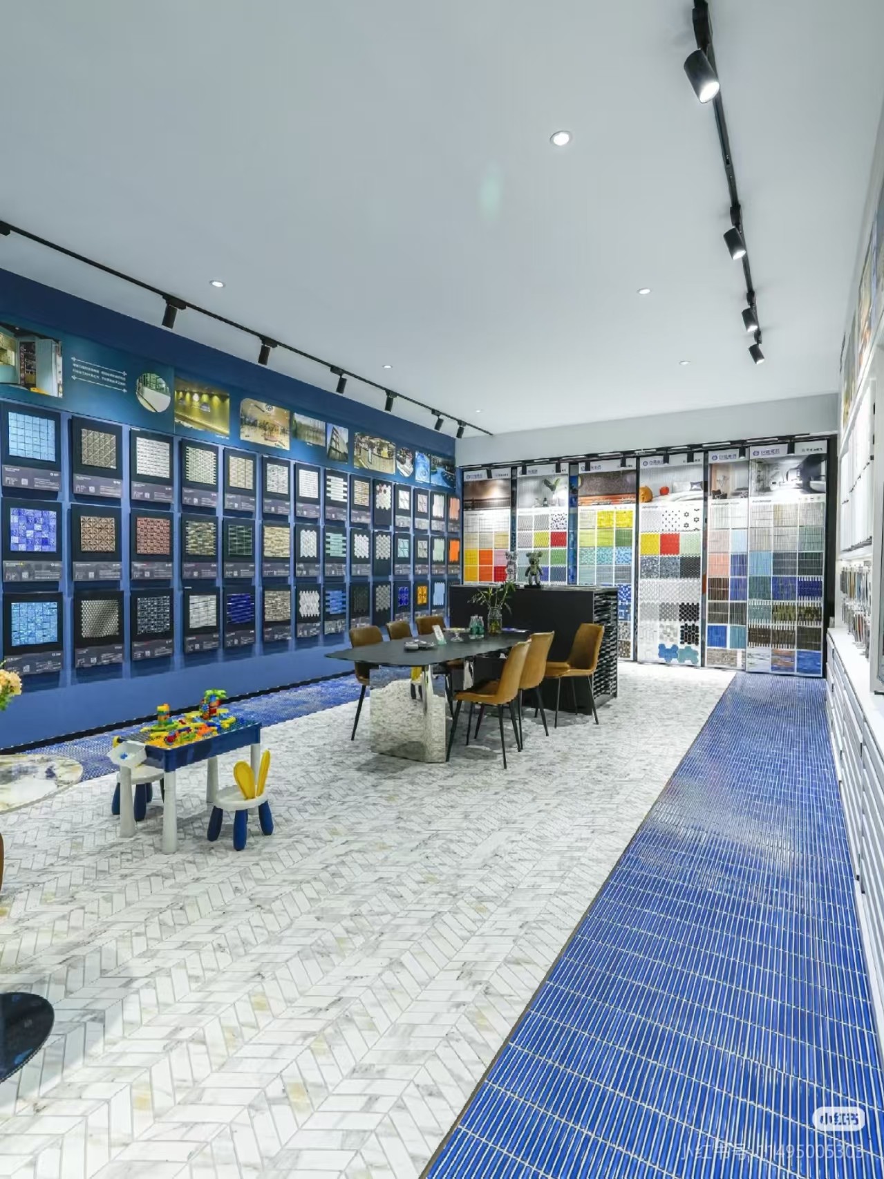HUITLONG MOSAIC showroom interior with mosaic sample displays and meeting area